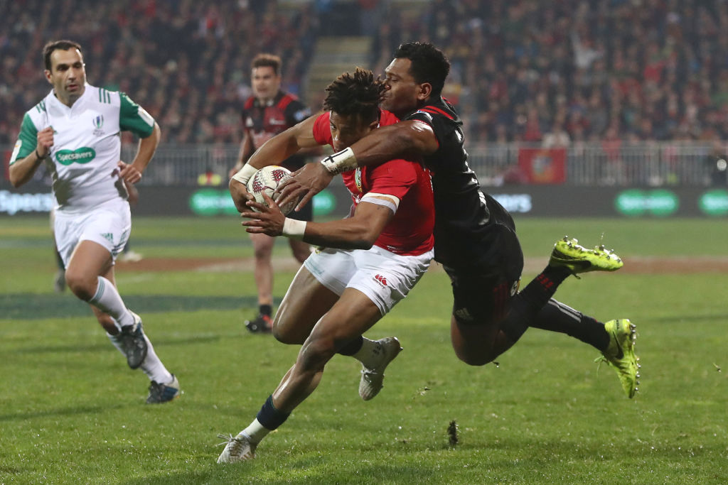 Anthony Watson of the Lions is tackled by Seta Tamanivalu of the Crusaders. Photo: Getty