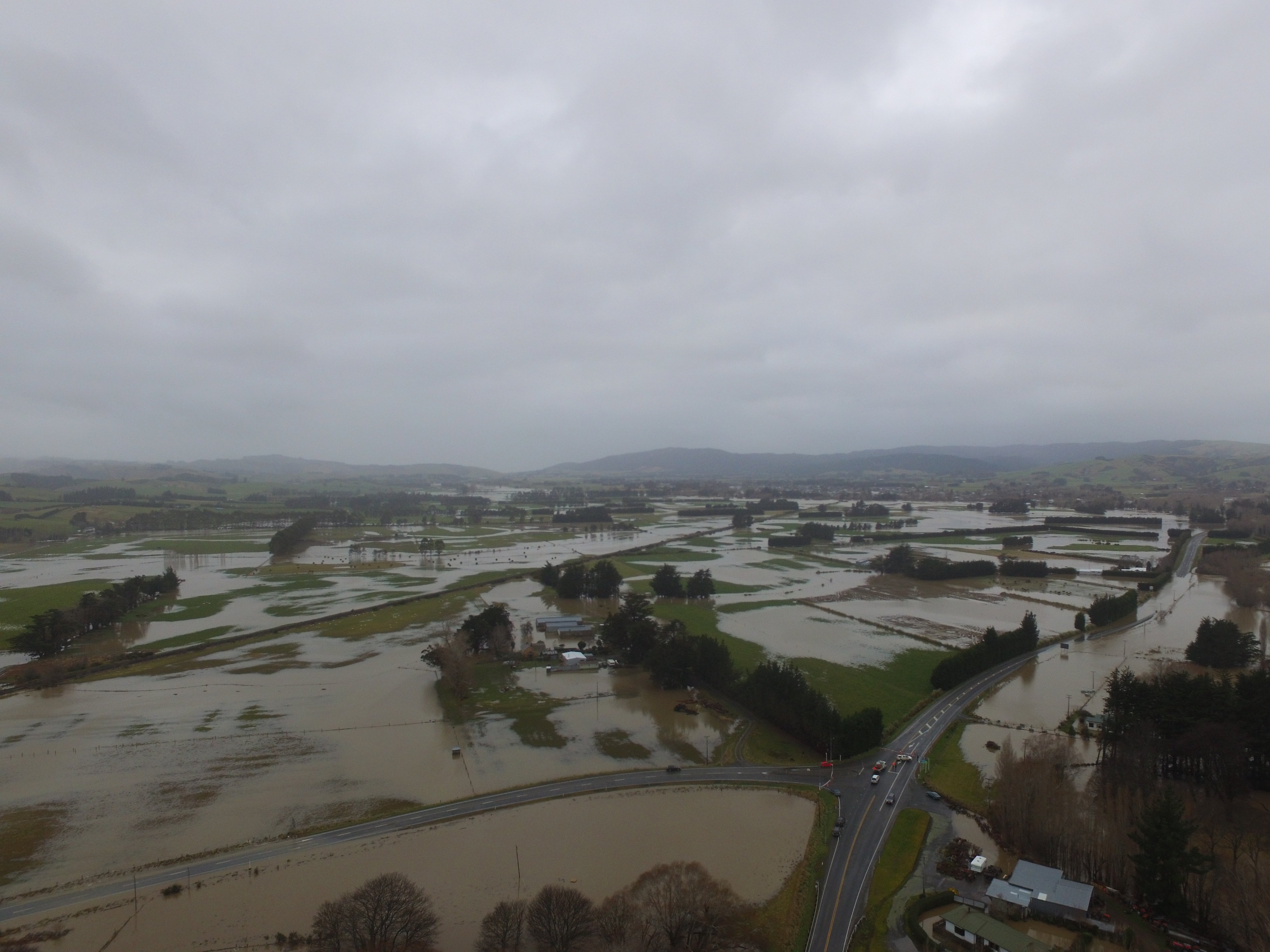 An aerial view shows water from the flooded Tokomairaro River spreading over the plains south of...