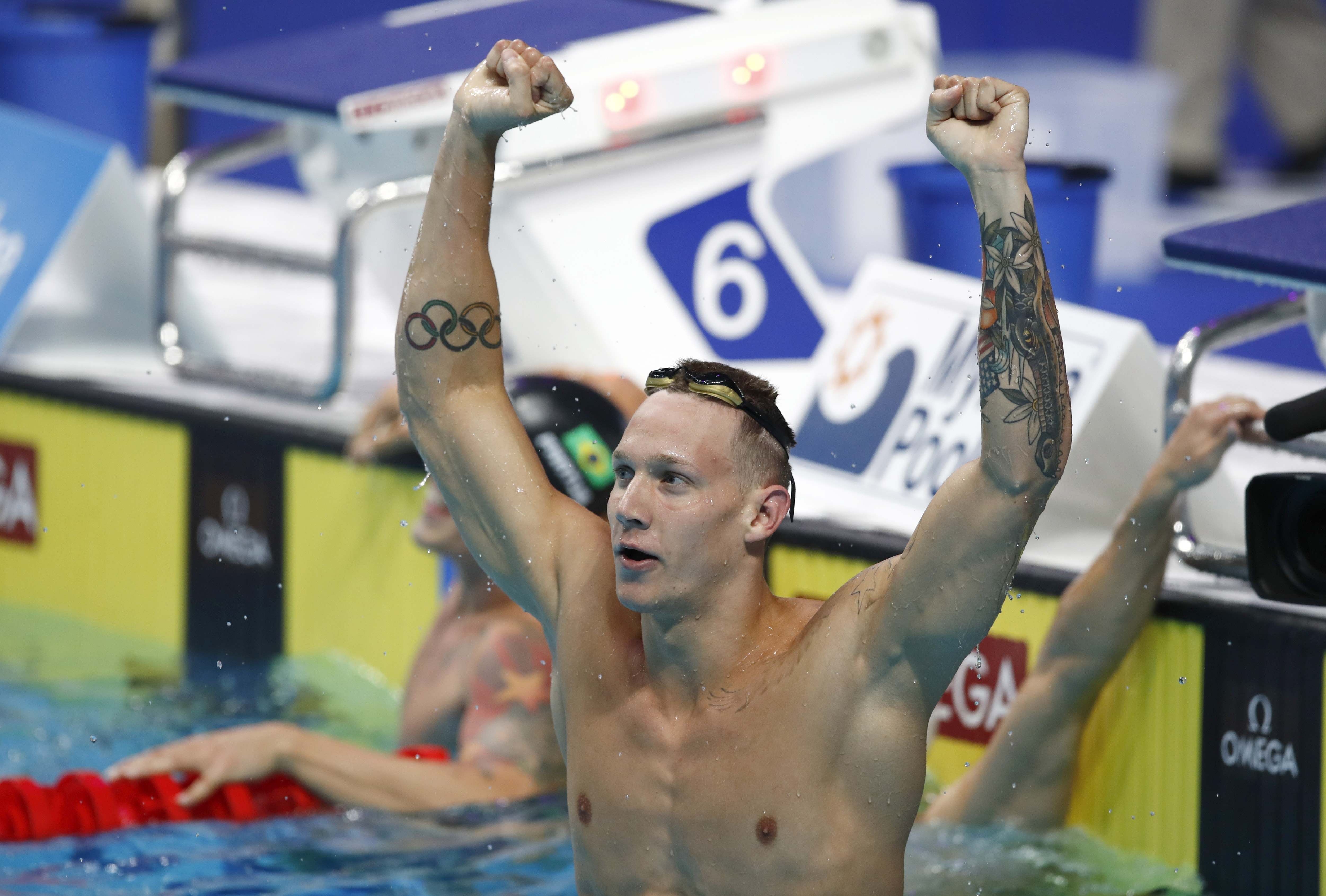 Caeleb Dressel celebrates one of his three gold medals last night. Photo: Reuters