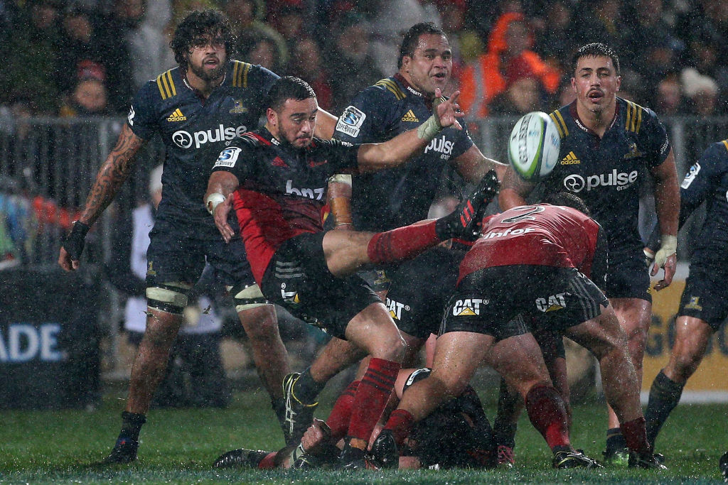 Bryn Hall of the Crusaders gets a kick away. Photo: Getty