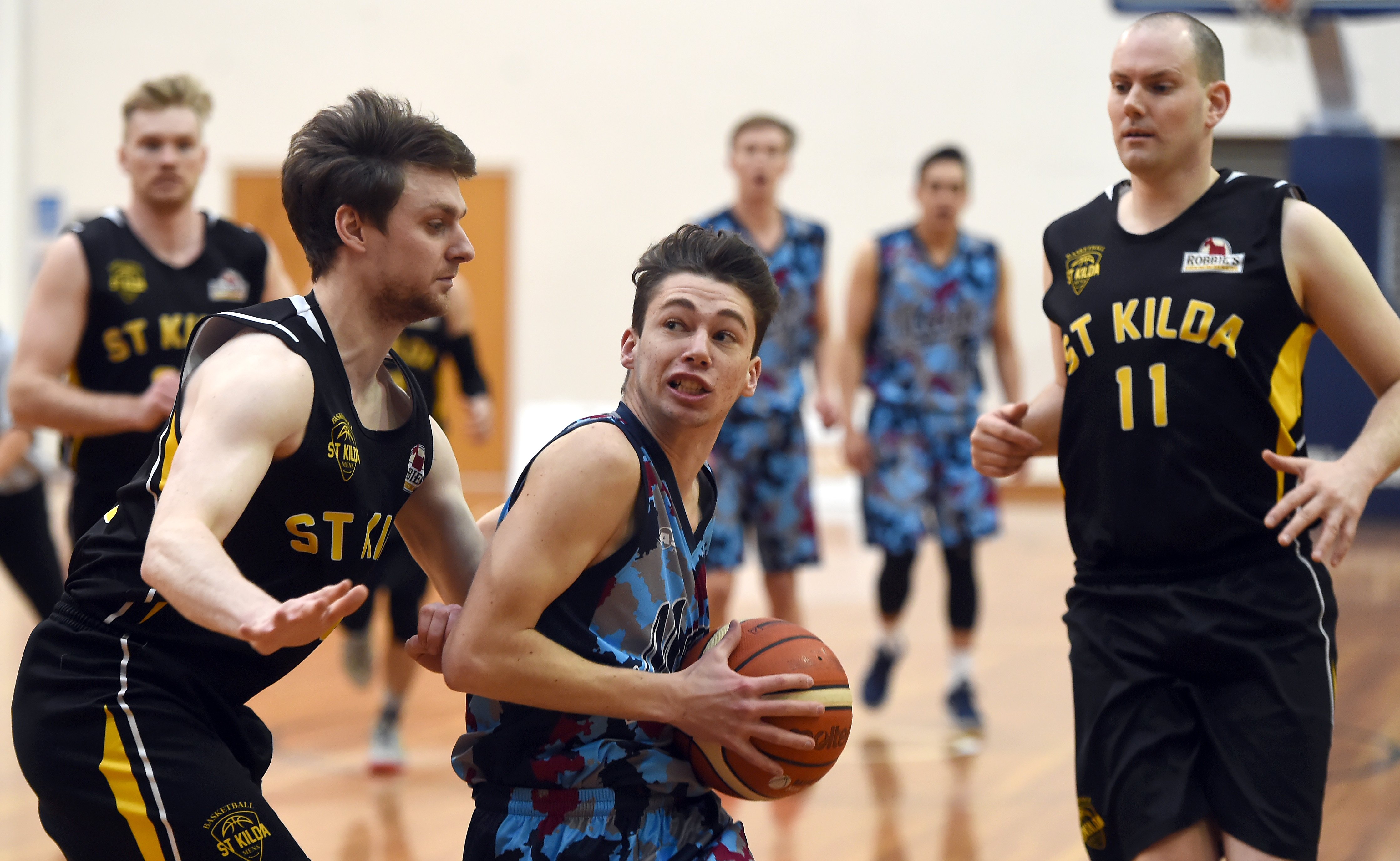 Duel... Magic guard Benoit Hayman has the ball but is closely watched by Saints' James Ross (left) and Matt Gillan at the Edgar Centre on Saturday. Photo:Gregor Richardson