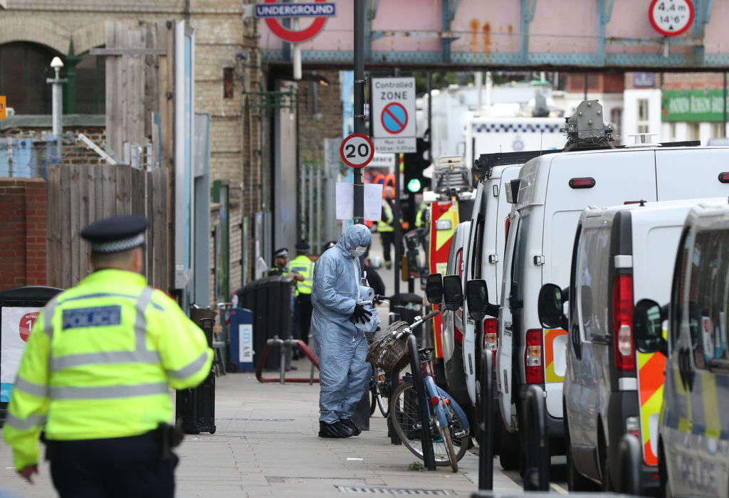 A forensic officer at work outside Parsons Green station in west London after the incident. Photo...