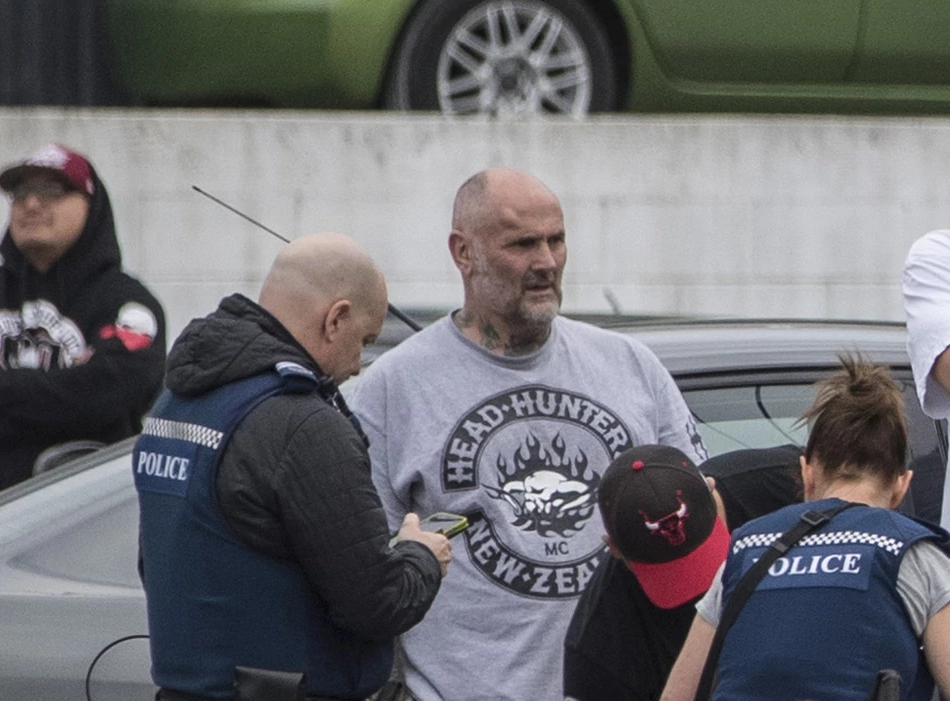 Police talk to Senior Head Hunters gang member Wayne Doyle. Photo: NZ Herald