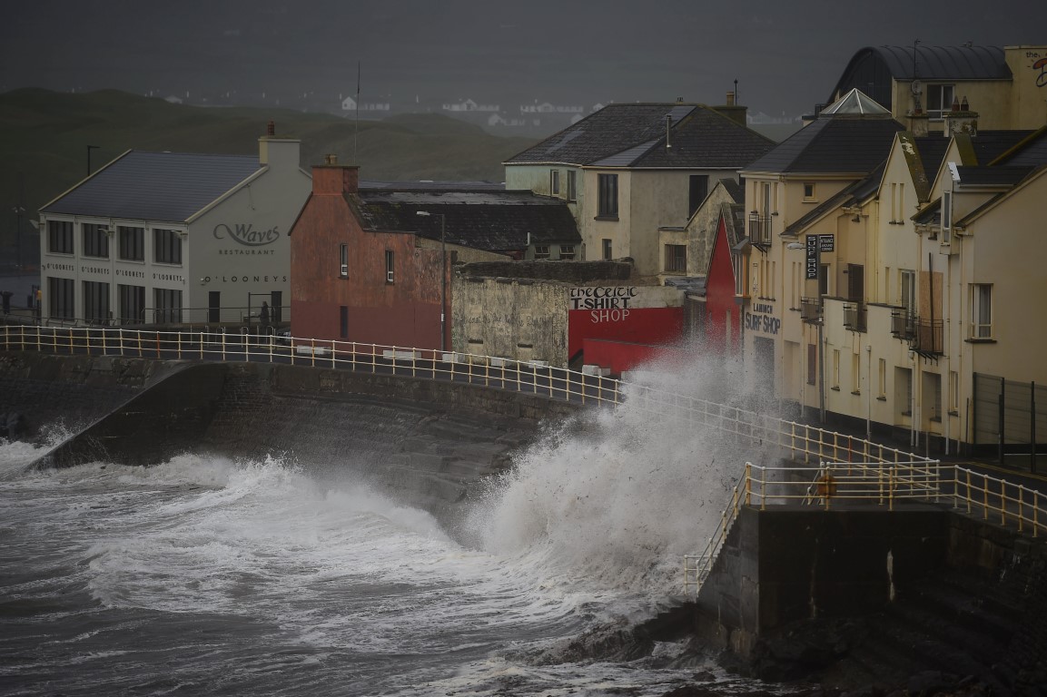 Waves slam the coast as the storm hits the County Clare town of Lahinch in Ireland. Photo Reuters 
