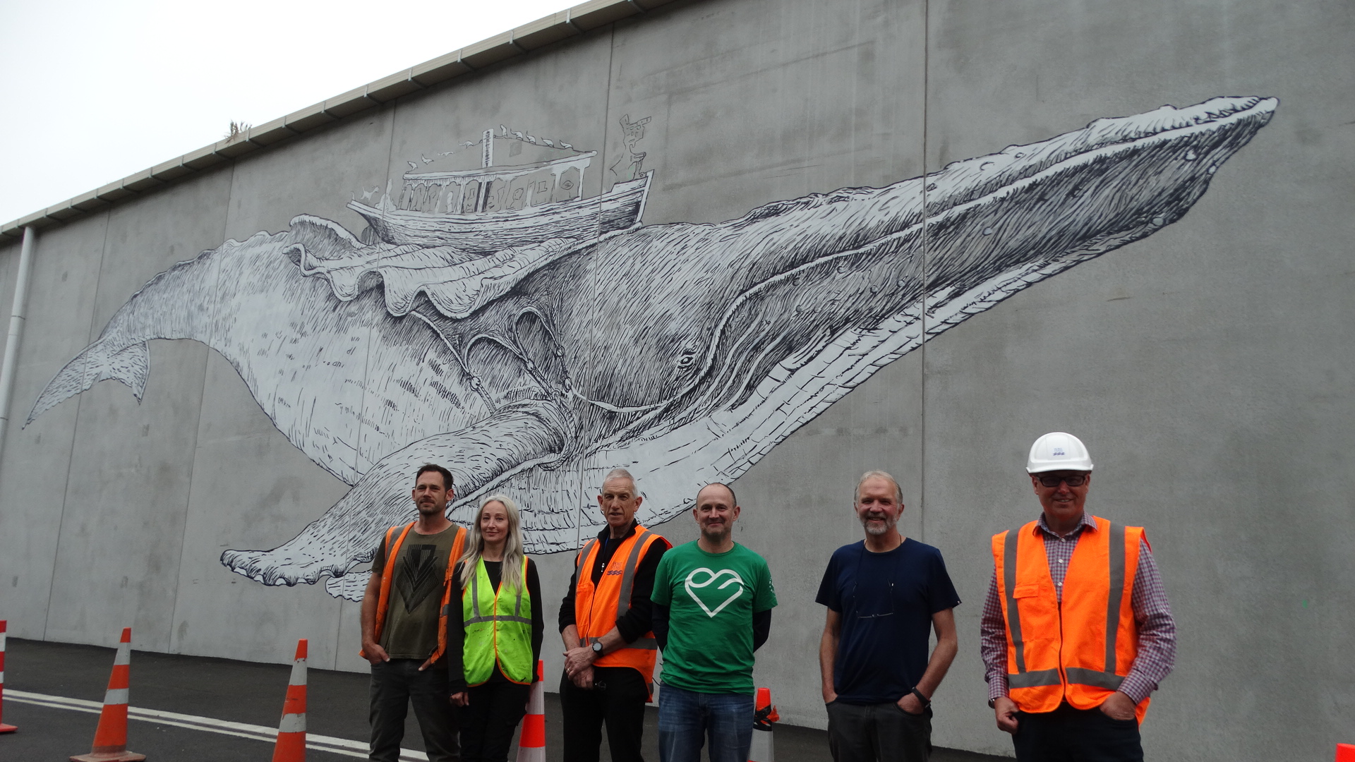 At Port Chalmers to view the almost-complete mural are (from left) artists Daniel Mead and Tessa Petley, Port Otago project manager Brian Corson, West Harbour Community Board chairman Steve Walker, author and illustrator David Elliot, and Port Otago chief