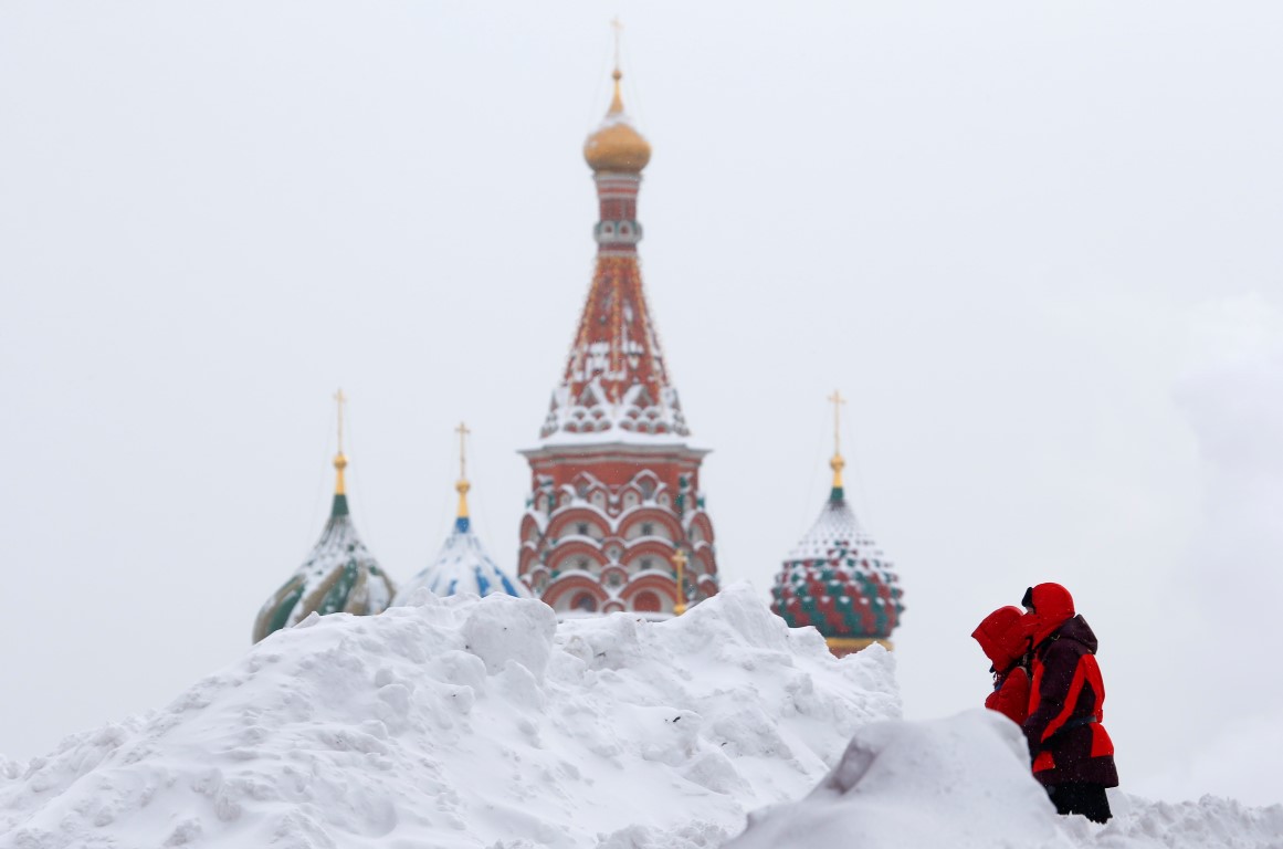 People walk in Red Square near St Basil's Cathedral after a heavy snowfall in central Moscow....