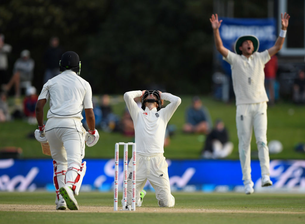 England captain Joe Root reacts as New Zealand's Ish Sodhi survives a delivery from Mark Wood...