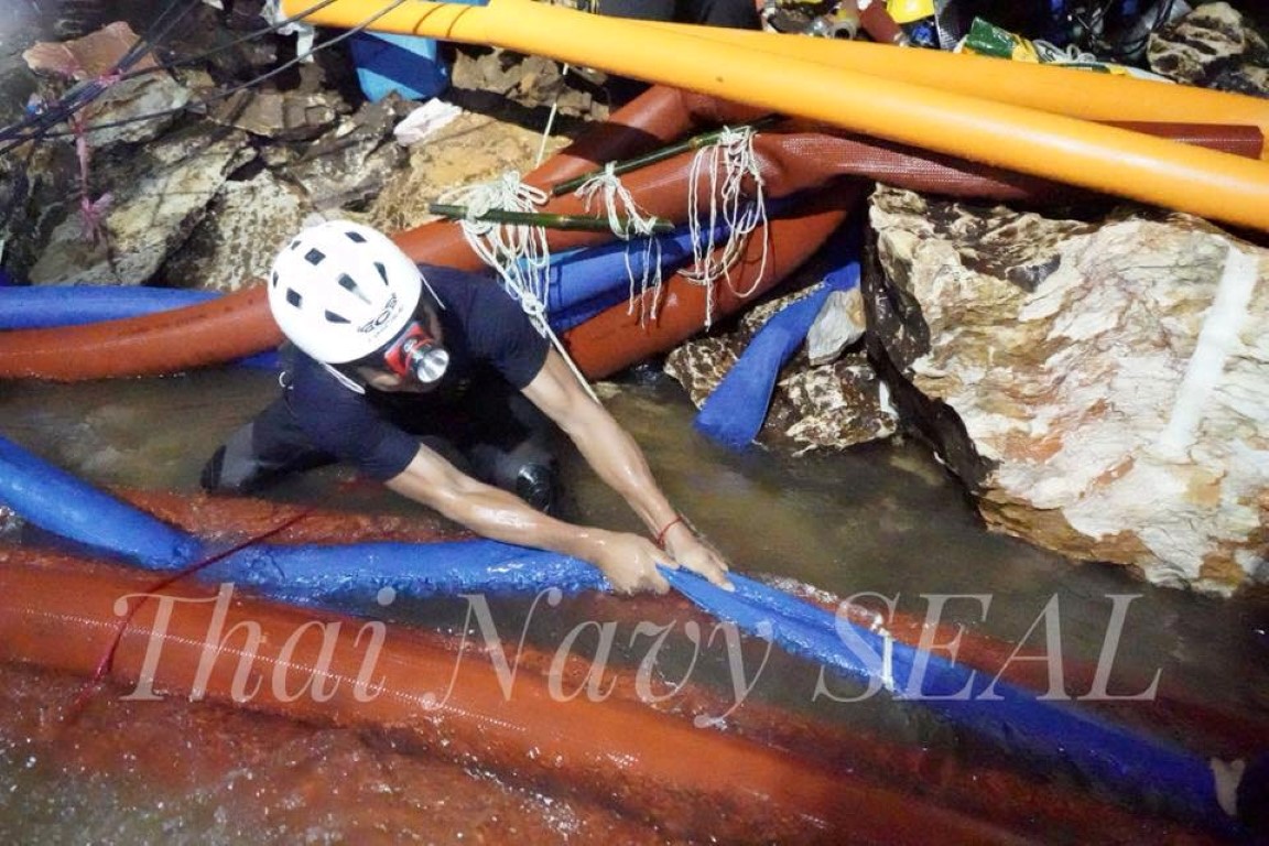 Rescue personnel work at the Tham Luang cave complex where the boys and their coach are trapped....