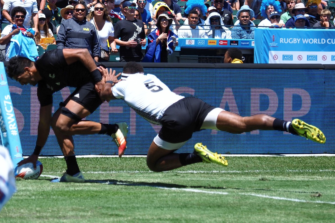 Dylan Collier dots down to score for New Zealand as Fiji's Semi Kunatani attempts a tackle. Photo...