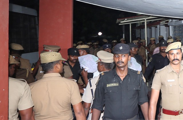 Police escort one of the men (face covered) accused of raping a 12-year girl inside the high court premises in Chennai. Photo: Reuters