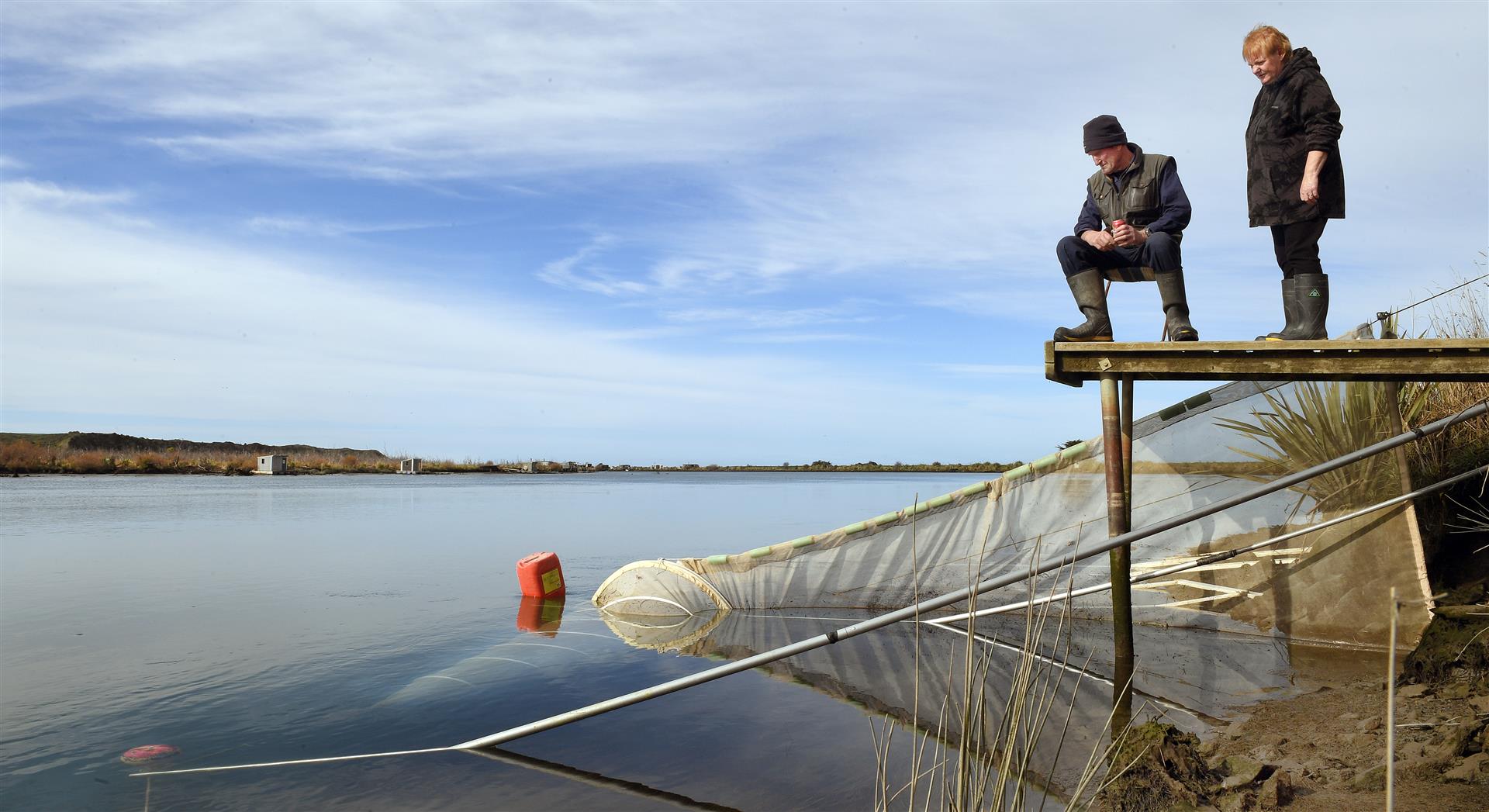 Colin and Christine Melvin at their whitebaiting stand near the Clutha River mouth yesterday. Photo: Stephen Jaquiery