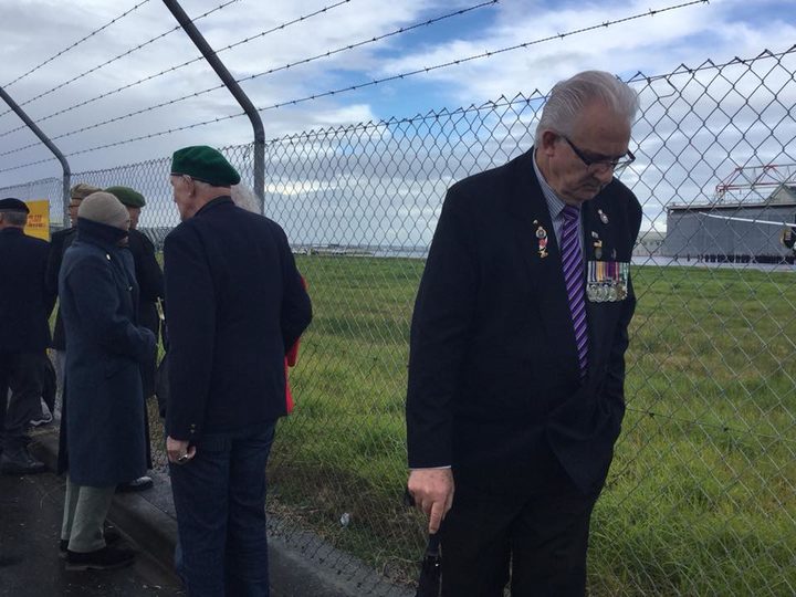 The Vietnam war veterans were only able to view the ceremony from some distance behind a wire...