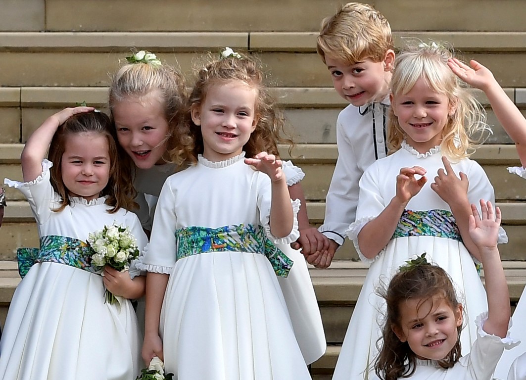 The bridesmaids and page boys, including Prince George and Princess Charlotte, wave after the...