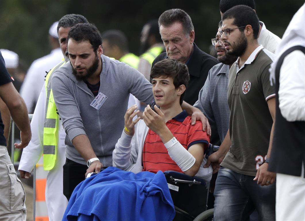 Zaed Mustafa, who was injured in the attacks, reacts during the burial of his father Khalid and...