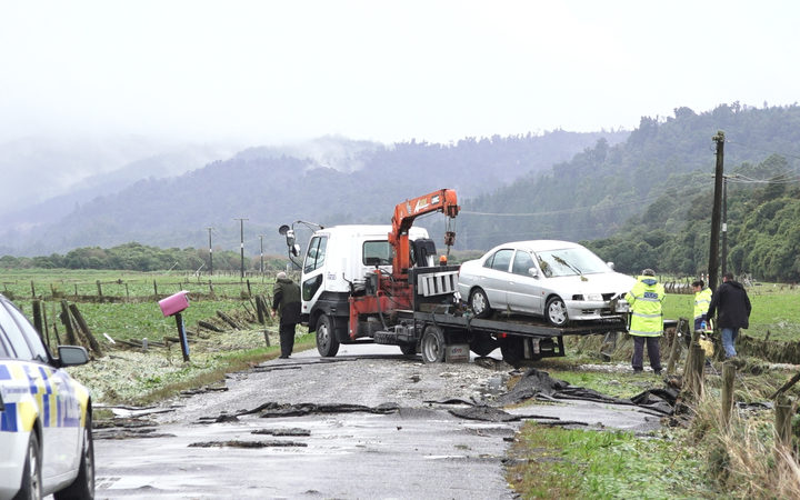 The car of a woman who died in flood waters north of Hokitika is removed. Photo: RNZ