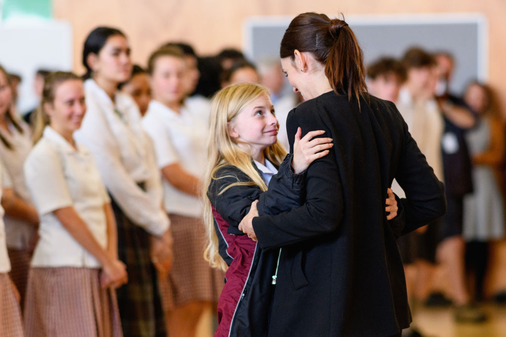 Prime Minister Jacinda Ardern receives a hug from a pupil. during her visit to Cashmere High...