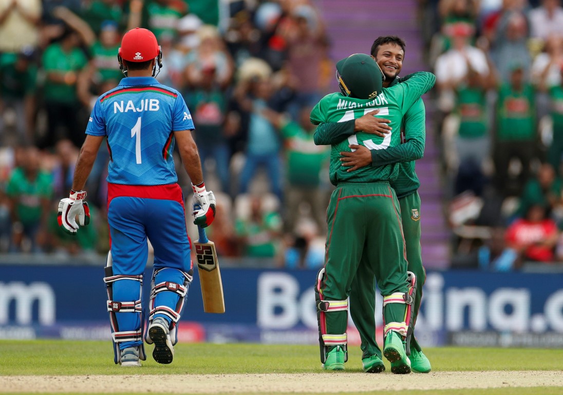 Bangladesh's Shakib Al Hasan and Mushfiqur Rahim celebrate taking the wicket of Afghanistan's...