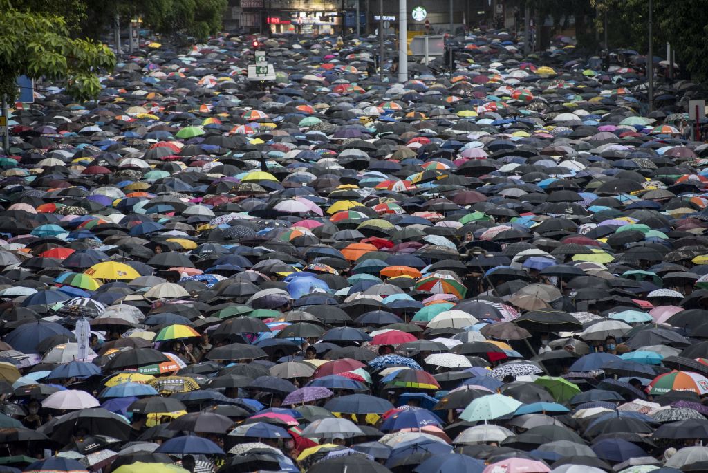 Huge crowds rally peacefully in Hong Kong rain | Otago Daily Times ...