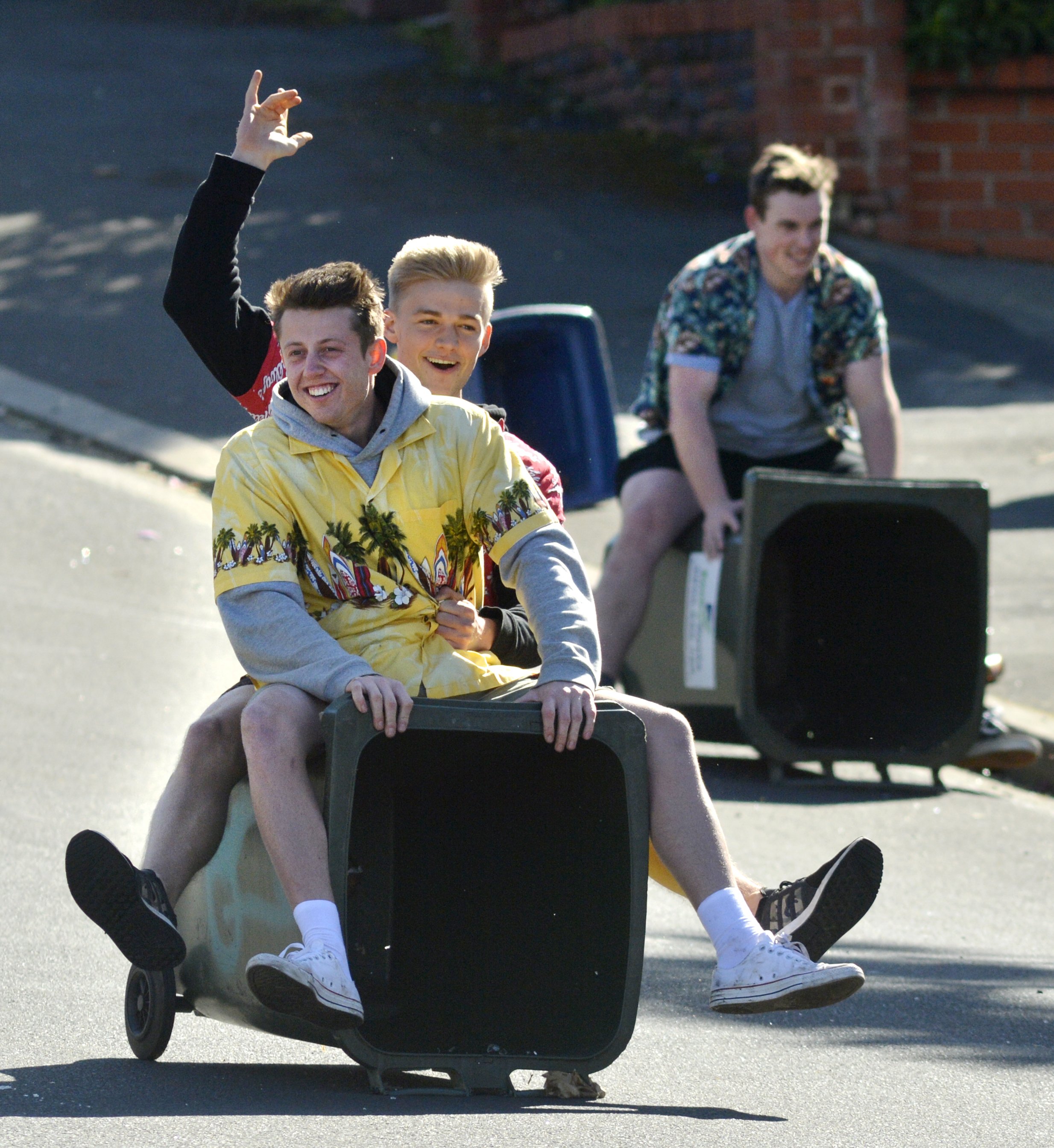 Young party-goers ride down Union St on a wheelie bin before Dunedin police arrived to put an end...