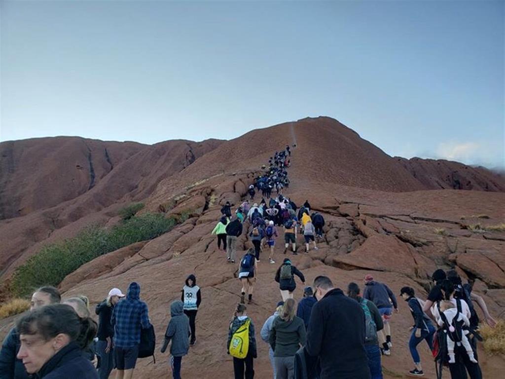 Tourists crowd a trail as they climb Uluru recently. Photo: Reuters