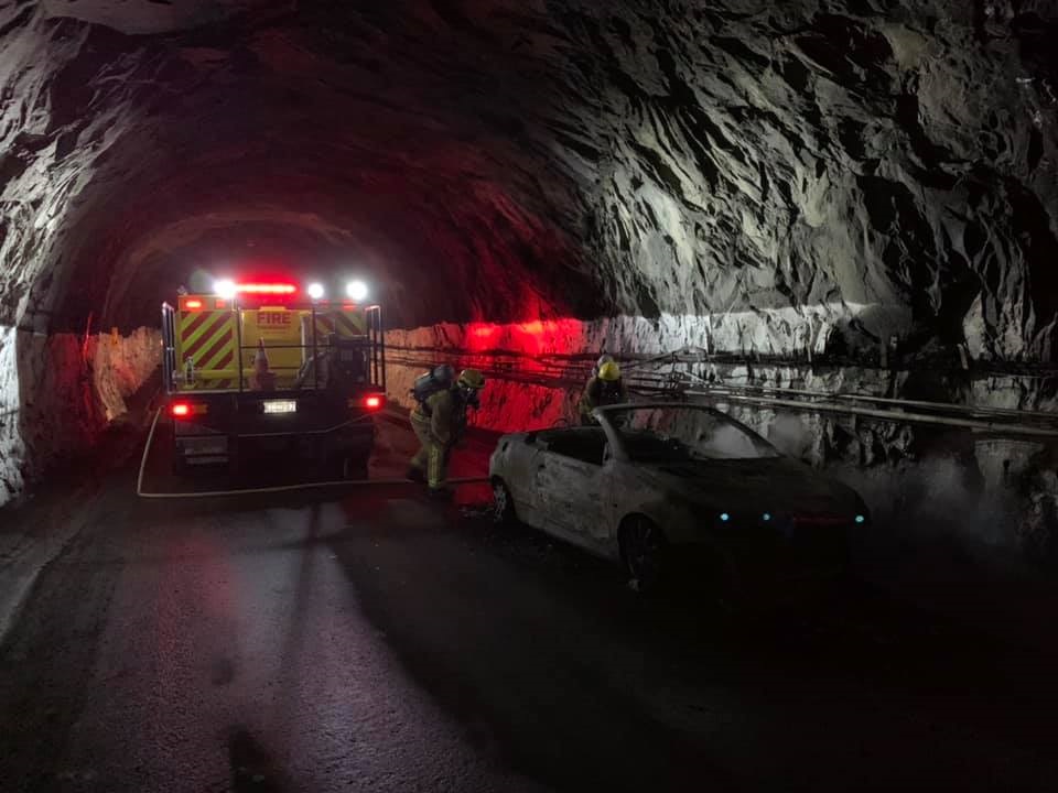 Fire crews inspect the charred vehicle inside the Homer Tunnel earlier today. Photo: Te Anau...