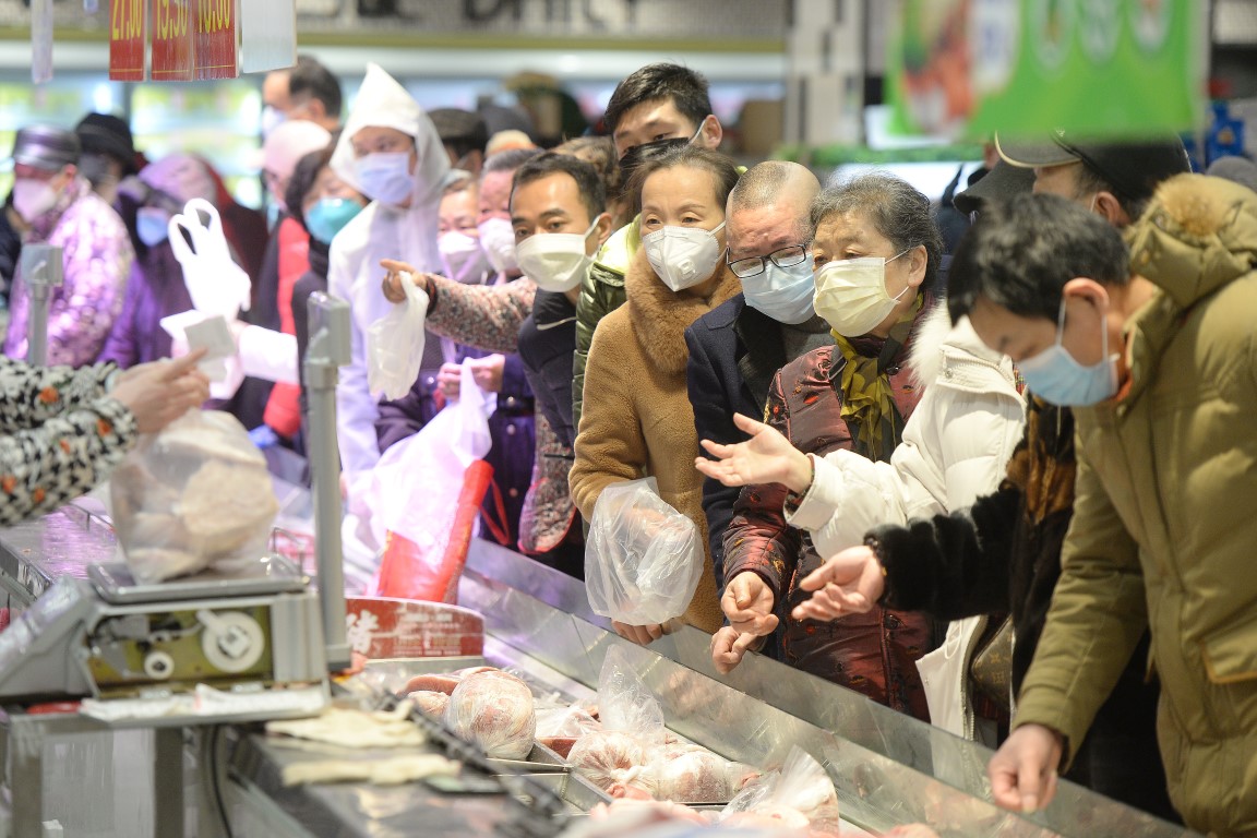 Customers wearing face masks shop inside a supermarket in Wuhan. Photo: Reuters