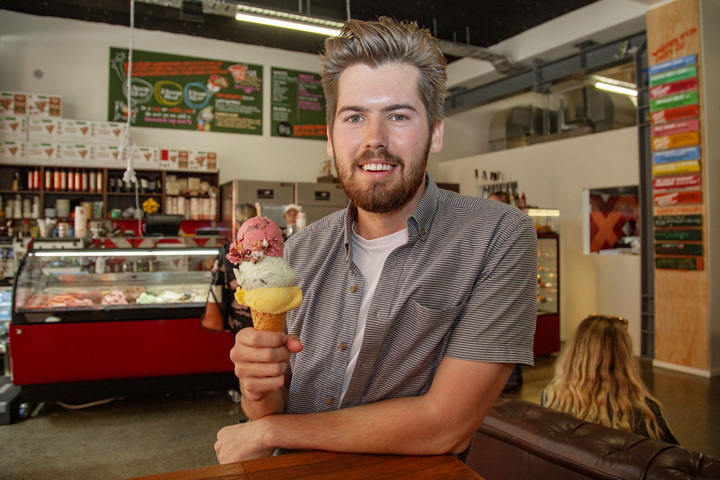 Rollickin' Gelato owner Jed Joyce with an impressive stack of gelato from his new Cashel St store...