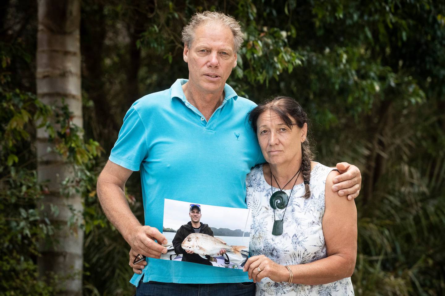 Kerry and Jenny Rogers hold a photograph of Tim, who died hours after a fall at Auckland's...