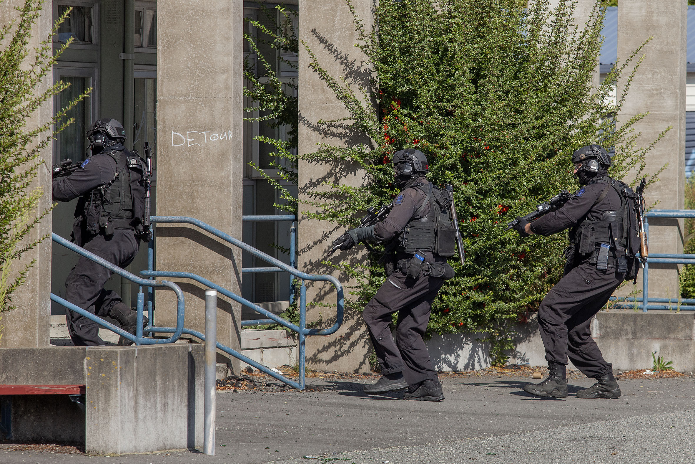 The special tactics group force their way into an abandoned building at Shirley Boys' High. Photo...