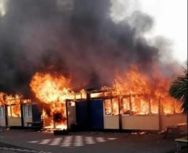 Classrooms engulfed by flames at South New Brighton School. Photo: Supplied via Facebook