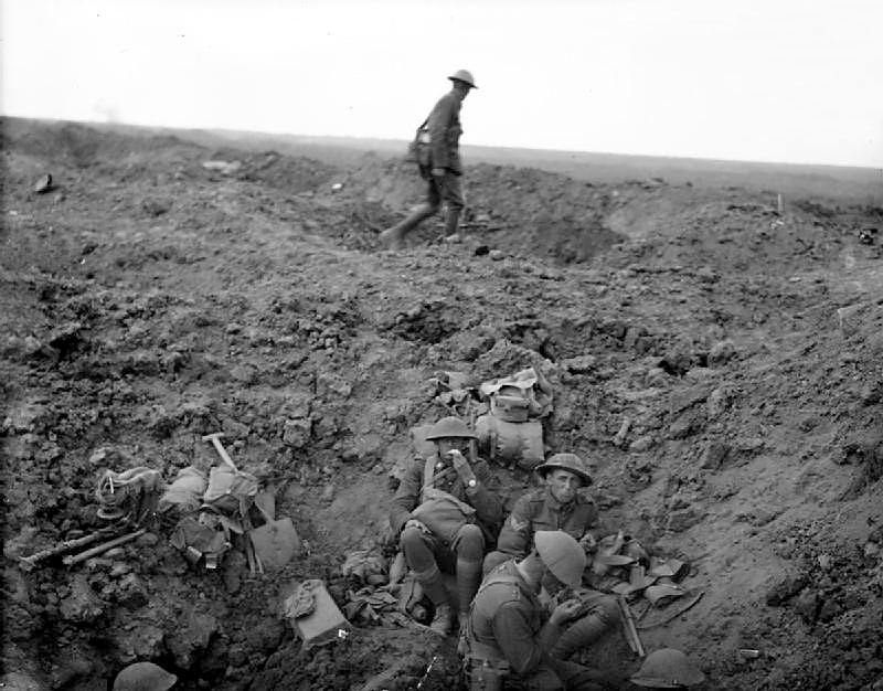 WWI. Men of the 2nd Canterbury Battalion, New Zealand Division, rest in a shell hole on the...