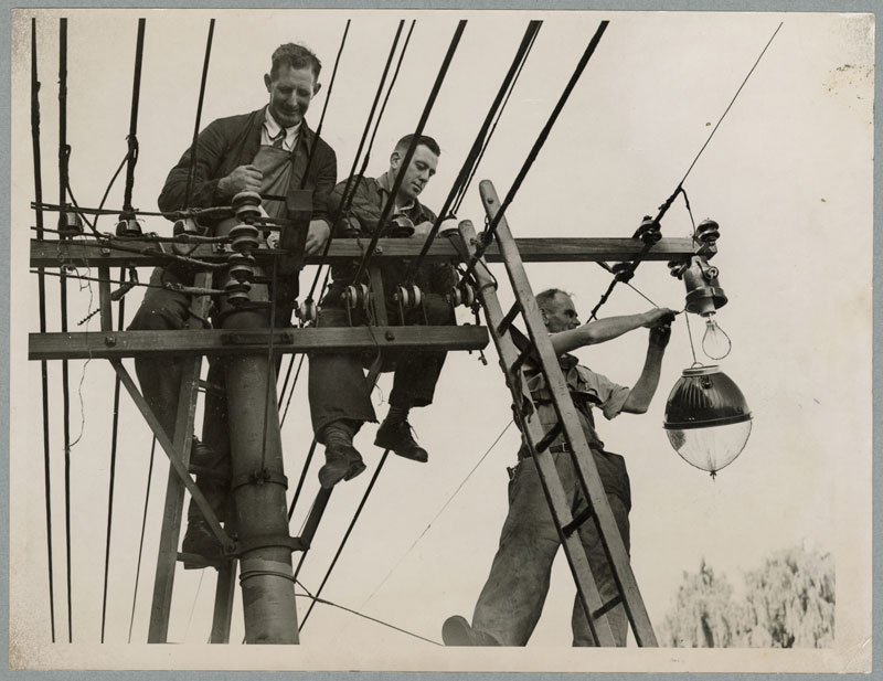 Municipal Electricity Department workers installing new lamps in the central city in 1945.