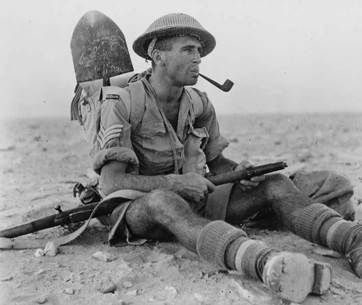 WWII. New Zealand Army Sergeant Ian Thomas smoking a pipe during the North African Campaign in...