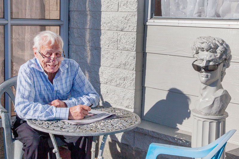 Enjoying the sun with a friend on Richill St, Belfast. "He doesn't talk much, and his jokes are...