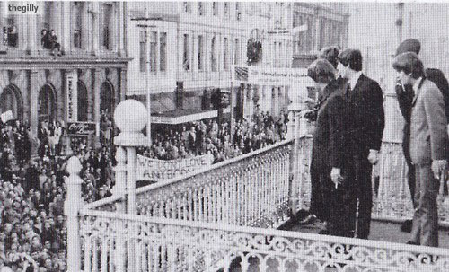 The Beatles wave to the crowd from the balcony at Clarendon Tower in 1964.