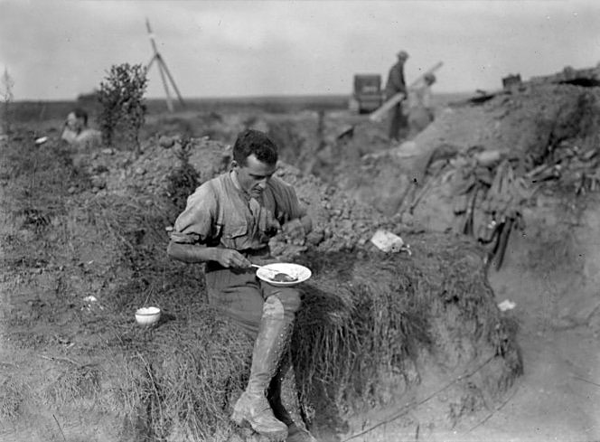 WWI. Victoria Cross recipient Sergeant Cyril Royston Guyton Bassett eating a meal in the trenches...