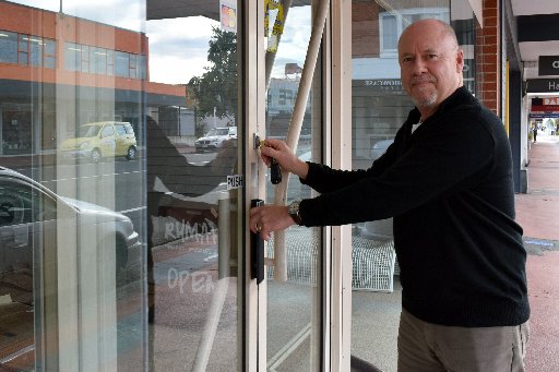 Rumah co-owner Lee Macaskill locks the door of his shop, ending nearly four years of retailing in...