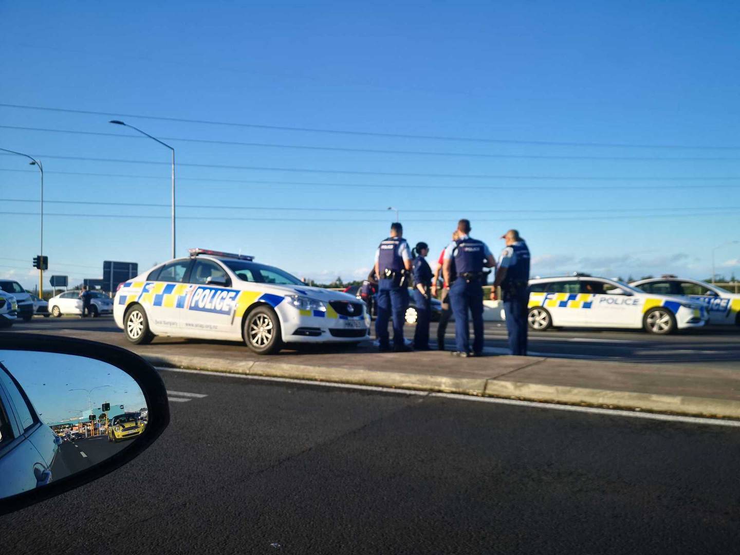 Police speak to someone after spiking a tyre on Lincoln Rd. Photo: Will Trafford