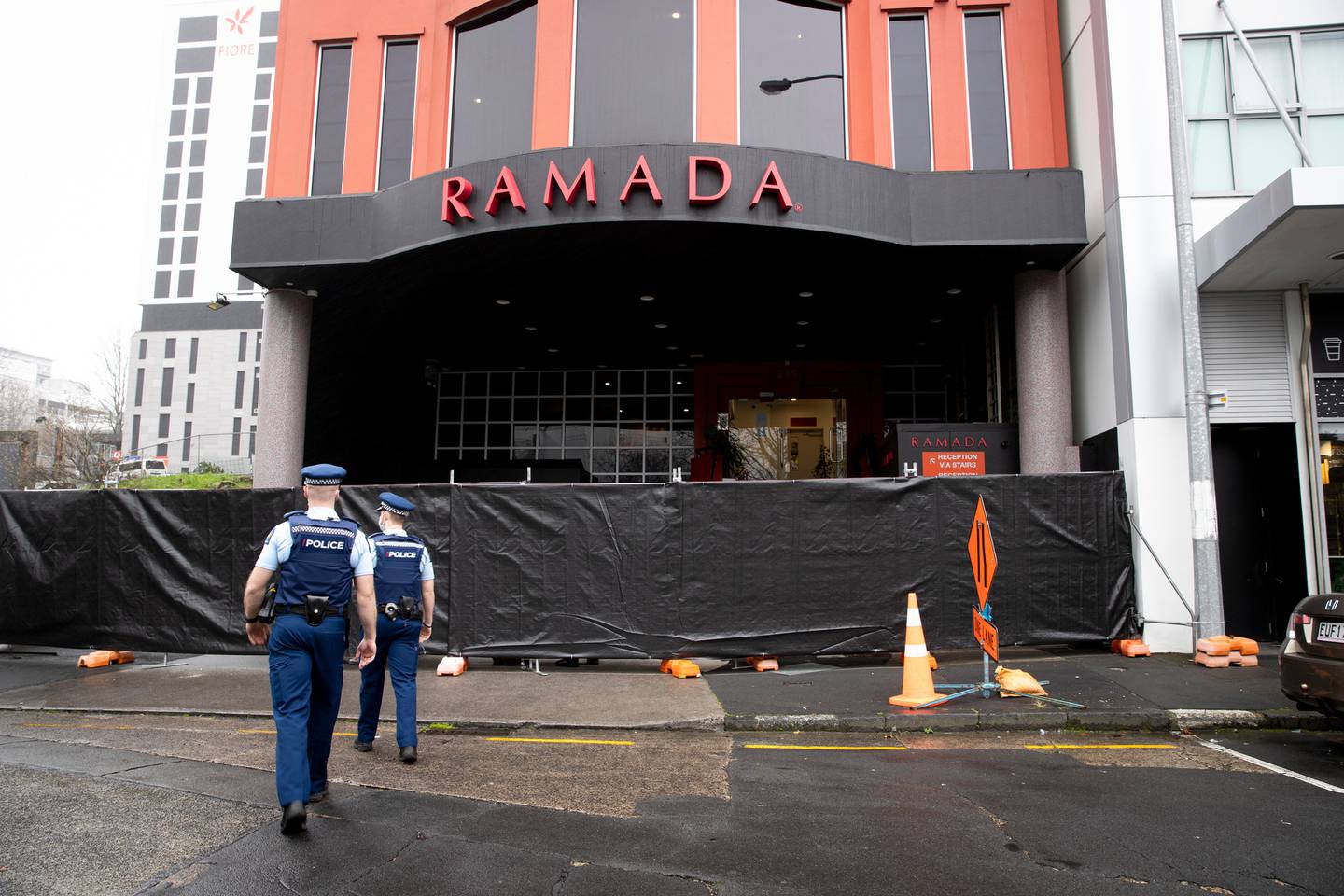 Four vans could be seen dropping off Australian deportees at the Ramada Suites by Wyndham...