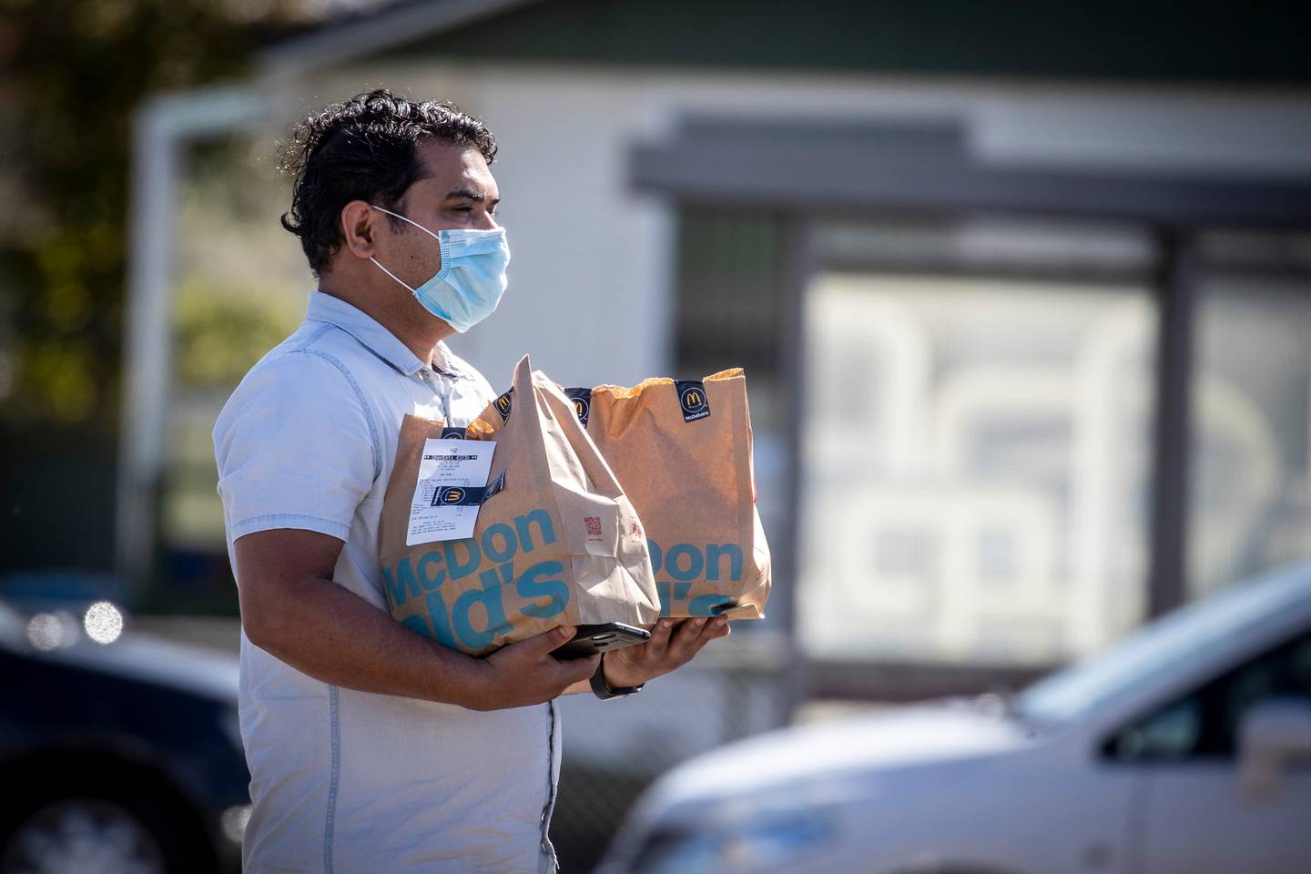 An UberEats delivery driver collects a meal from McDonald's in April. Photo: Michael Craig / NZH