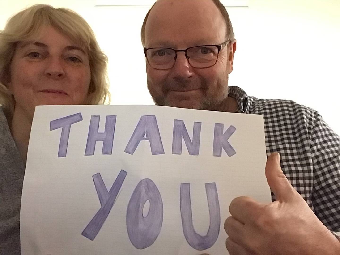 Jacky and Miles Fawcett with a sign they made to thank the staff at Hamilton's Jet Park Hotel...