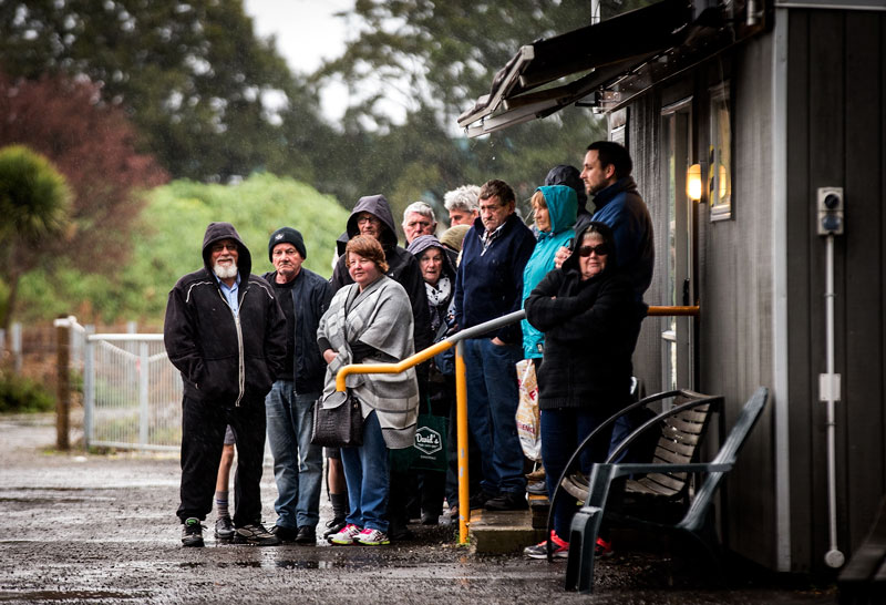 People wait in the rain for the Hospital Shuttle back in 2017. Photo: Martin Hunter