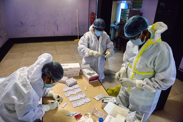 Healthcare workers in India with rapid testing kits for coronavirus. Photo: Getty Images