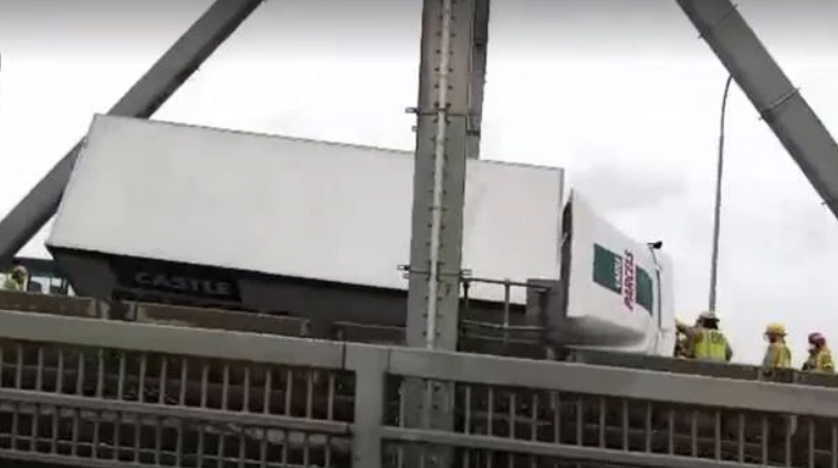 A Castle Parcels truck was tipped over on the Auckland Harbour Bridge on Friday morning. Photo:...