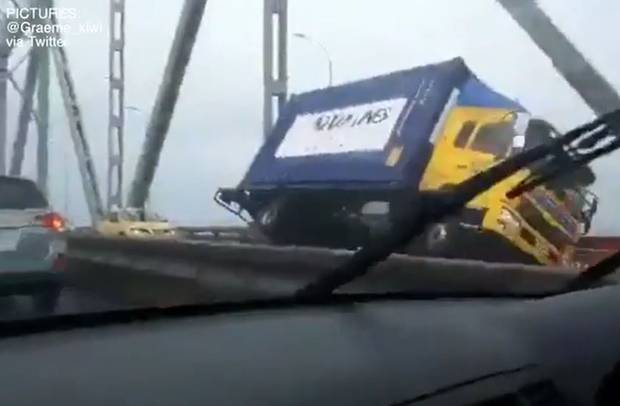 A NZ Van Lines truck was also tipped over, causing damage to the bridge. Image: Graeme_Kiwi via...