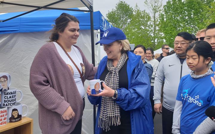 Judith Collins (centre) with Lisa Stirling (left) gets a look at the mug. Photo: RNZ