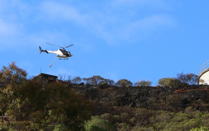 At first light today two helicopters carried out an aerial survey of the fire. Photo: RNZ