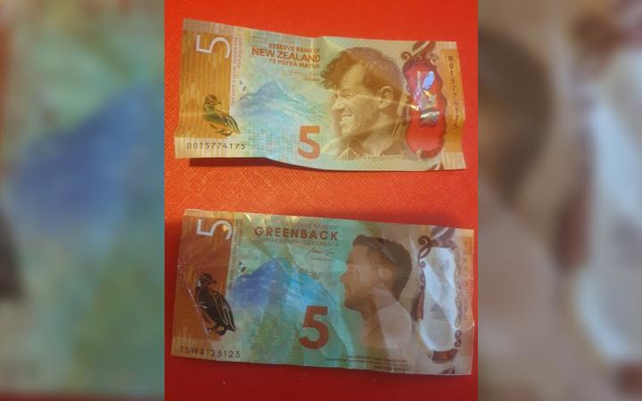 A real $5 note (top) and a fake $5 note given out at the Safety Warehouse promotion. Photo:...