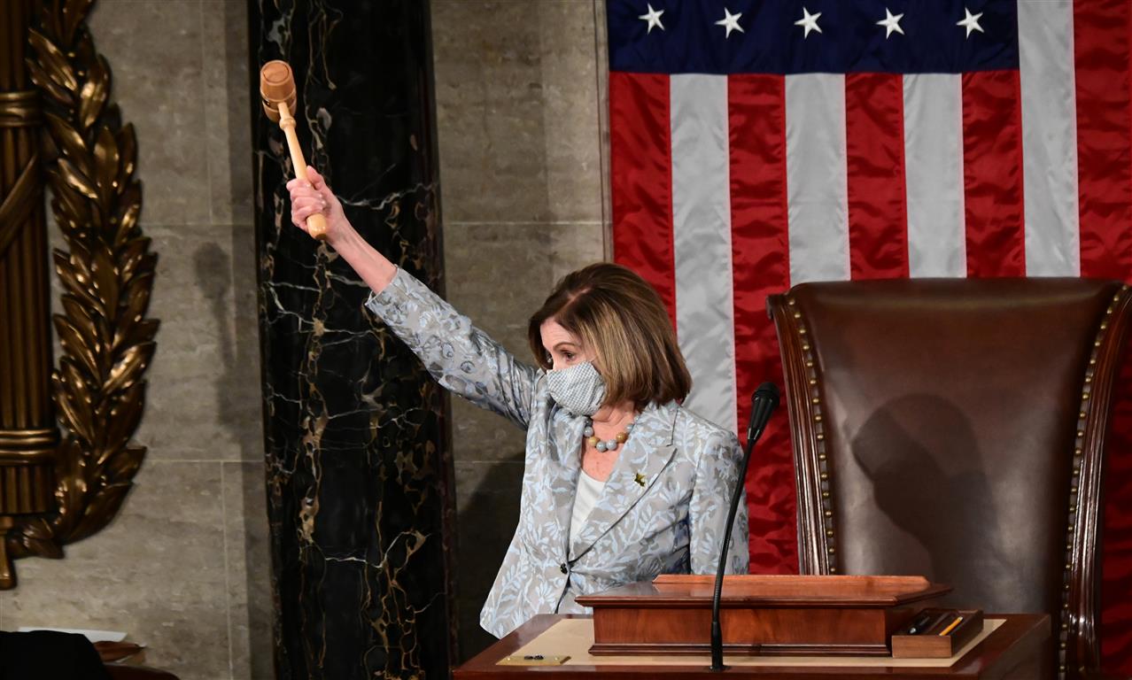 Nancy Pelosi wields the Speaker's gavel after being re-elected as Speaker of the 117th House of...