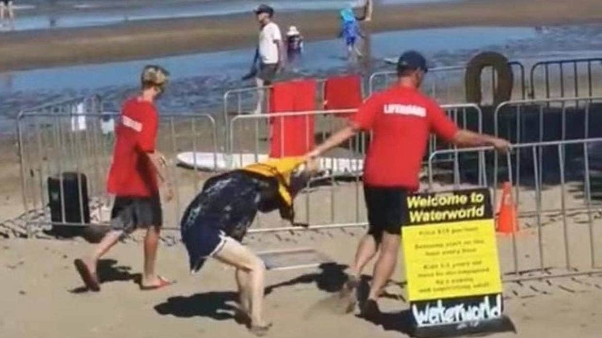 A woman being dragged by male staff member of Auckland water park. Photo: RNZ/Supplied